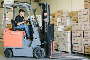 Forklift driver at Valley Sanitary Supply warehouse.